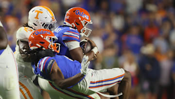 Florida wide receiver TJ Abrams (4) and Florida quarterback DJ Lagway (2) gets snatched off their feet by Tennessee defensive lineman Joshua Josephs (19) and Tennessee defensive lineman Tyre West (42) during the second half of an NCAA football game against Tennessee at Steve Spurrier Field at Ben Hill Griffin Stadium in Gainesville, FL on Saturday, November 22, 2025. Florida lost to Tennessee 31-11[Alan Youngblood/Gainesville Sun]