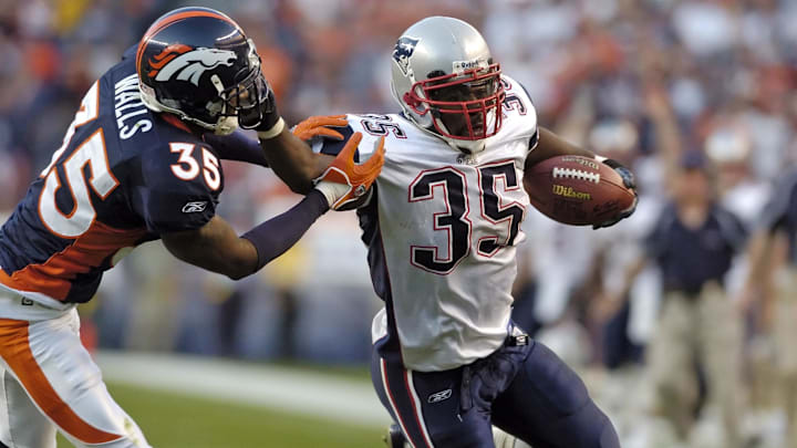 Oct 16, 2005; Denver, CO, USA; New England Patriots full back #35 Patrick Pass holds off Denver Broncos cornerback #35 Lenny Walls in the fourth quarter at Invesco Field at Mile High.