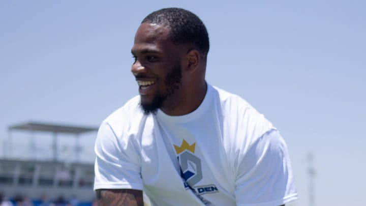 Dallas Cowboys' Micah Parsons five-highs kids during his youth football camp at Lubbock Christian High School.