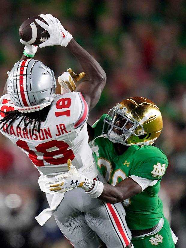 Ohio State Buckeyes wide receiver Marvin Harrison Jr. (18) and Notre Dame Fighting Irish cornerback Benjamin Morrison (20) 
