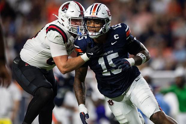 Auburn Tigers defensive end Keldric Faulk blitzes as Auburn Tigers take on Ball State Cardinals.