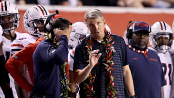 Sep 28, 2024; Salt Lake City, Utah, USA; Arizona Wildcats head coach Brent Brennan (center) during the third quarter against the Utah Utes at Rice-Eccles Stadium. Mandatory Credit: Rob Gray-Imagn Images