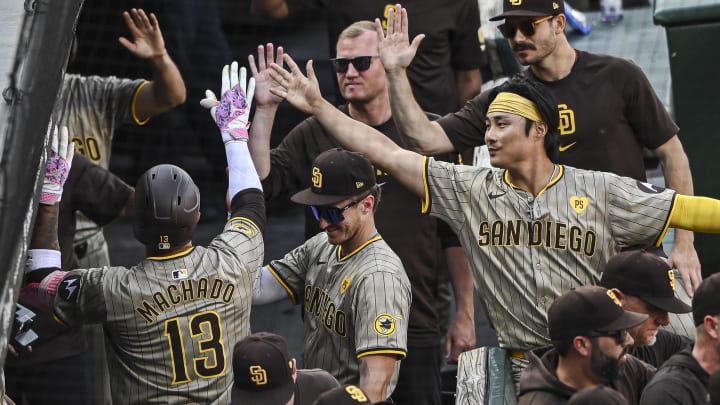 Jul 27, 2024; Baltimore, Maryland, USA;  San Diego Padres third baseman Manny Machado (13) celebrates with teammates in the dugout after  hitting a three run home run against the Baltimore Orioles in the seventh inning at Oriole Park at Camden Yards. Mandatory Credit: Tommy Gilligan-USA TODAY Sports