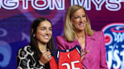 Georgia Amoore poses with WNBA commissioner Cathy Engelbert after being selected with the number six overall pick to the Washington Mystics.