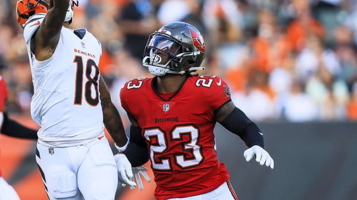 Aug 10, 2024; Cincinnati, Ohio, USA; Cincinnati Bengals wide receiver Kwamie Lassiter II (18) attempts to catch a pass against Tampa Bay Buccaneers safety Tykee Smith (23) in the first half at Paycor Stadium. Mandatory Credit: Katie Stratman-USA TODAY Sports