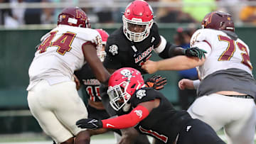Savannah Christian's Jaden Miles and LaDamion Guyton look to stop New Hampstead's Kameron Blake-Mazes in the backfield on Friday, August 23, 2024 at Pooler Stadium.