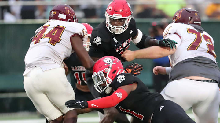 Savannah Christian's Jaden Miles and LaDamion Guyton look to stop New Hampstead's Kameron Blake-Mazes in the backfield on Friday, August 23, 2024 at Pooler Stadium.