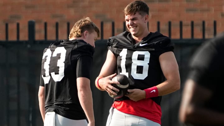 Aug 1, 2024; Columbus, OH, USA; Ohio State Buckeyes quarterback Will Howard (18) laughs with quarterback Devin Brown (33) during football camp at the Woody Hayes Athletic Complex.