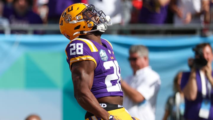 Jan 1, 2024; Tampa, FL, USA;  LSU Tigers running back Kaleb Jackson (28) scores a touchdown against the Wisconsin Badgers in the second quarter during the ReliaQuest Bowl at Raymond James Stadium. Mandatory Credit: Nathan Ray Seebeck-USA TODAY Sports