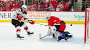 New Jersey Devils center Paul Cotter scores a goal past Carolina Hurricanes goalie Dustin Tokarski.