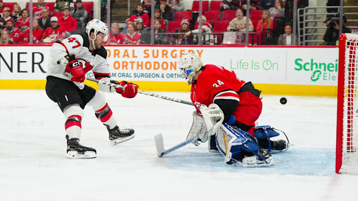 New Jersey Devils center Paul Cotter scores a goal past Carolina Hurricanes goalie Dustin Tokarski. New Jersey Devils center Paul Cotter scores a goal past Carolina Hurricanes goalie Dustin Tokarski.