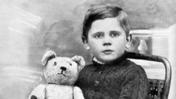 A rather intense child with his teddy bear circa 1906.