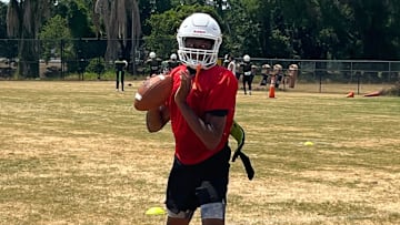 Jones quarterback Dereon Coleman sets up to throw during practice Friday in Orlando.