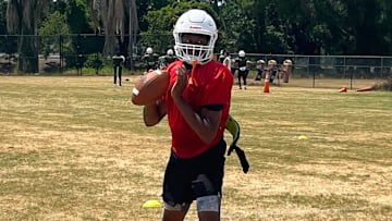 Jones quarterback Dereon Coleman sets up to throw during practice Friday in Orlando.