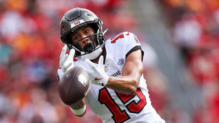 Sep 8, 2024; Tampa, Florida, USA;  Tampa Bay Buccaneers wide receiver Jalen McMillan (15) reaches for a pass against the Washington Commanders in the first quarter at Raymond James Stadium. Mandatory Credit: Nathan Ray Seebeck-Imagn Images