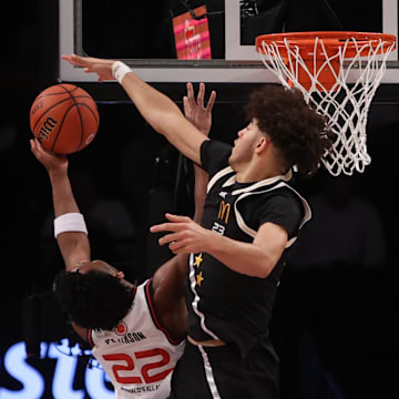 Apr 1, 2025; Brooklyn, NY, USA; McDonald's All American East center Malachi Moreno (23) blocks a shot by McDonald's All American West guard Darryn Peterson (22) during the second half of the game at Barclays Center. Mandatory Credit: Pamela Smith-Imagn Images