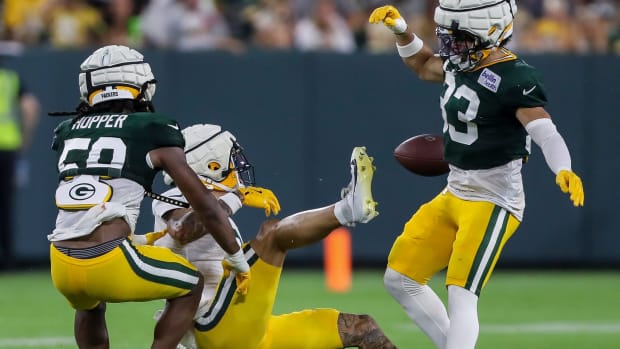 Evan Williams (33) breaks up a pass intended for wide receiver Christian Watson (9)