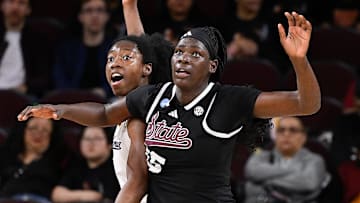 Mar 22, 2025; Los Angeles, California, USA;  California Golden Bears forward Ugonne Onyiah (0) and Mississippi State Bulldogs center Madina Okot (15) fight for position under the basket during the 2nd quarter of an NCAA Tournament game at Galen Center. Mandatory Credit: Robert Hanashiro-Imagn Images