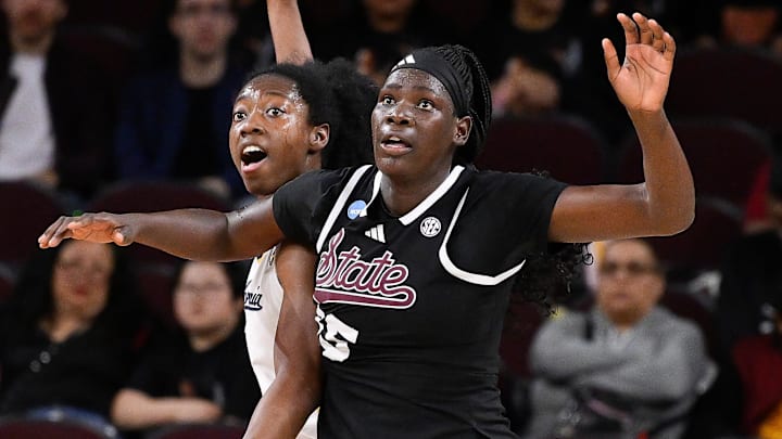 Mar 22, 2025; Los Angeles, California, USA;  California Golden Bears forward Ugonne Onyiah (0) and Mississippi State Bulldogs center Madina Okot (15) fight for position under the basket during the 2nd quarter of an NCAA Tournament game at Galen Center. Mandatory Credit: Robert Hanashiro-Imagn Images