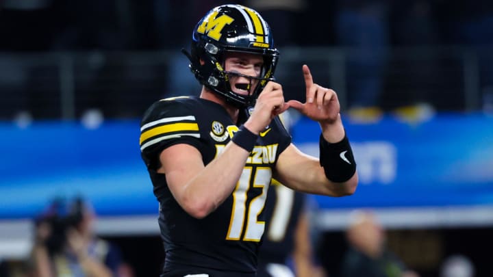 Dec 29, 2023; Arlington, TX, USA;  Missouri Tigers quarterback Brady Cook (12) reacts after a touchdown during the second half against the Ohio State Buckeyes at AT&T Stadium. Mandatory Credit: Kevin Jairaj-USA TODAY Sports