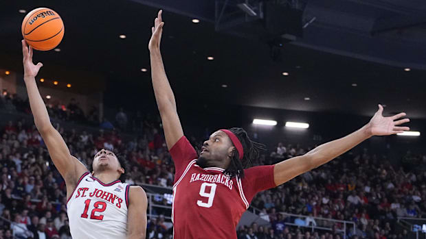 Arkansas Razorbacks center Jonas Aidoo (9) disrupts the shot of St. John's Red Storm guard RJ Luis Jr. during the first half 