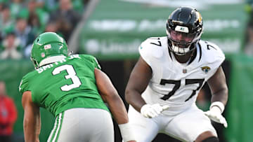 Nov 3, 2024; Philadelphia, Pennsylvania, USA;  Jacksonville Jaguars offensive tackle Anton Harrison (77) prepares to block Philadelphia Eagles linebacker Nolan Smith Jr. (3) at Lincoln Financial Field. Mandatory Credit: Eric Hartline-Imagn Images