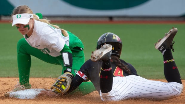 Oregon   s Paige Sinicki, left, tries unsuccessfuly for the tag of Maryland   s Megan Mikami at second during the Jane Sander
