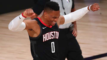 Russell Westbrook throwing his arms up in celebration while playing for the Rockets