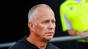 Aug 28, 2025; Raleigh, North Carolina, USA; North Carolina State Wolfpack head coach Dave Doeren walks out during the warmups prior to the game against East Carolina Pirates at Carter-Finley Stadium. Mandatory Credit: Jaylynn Nash-Imagn Images