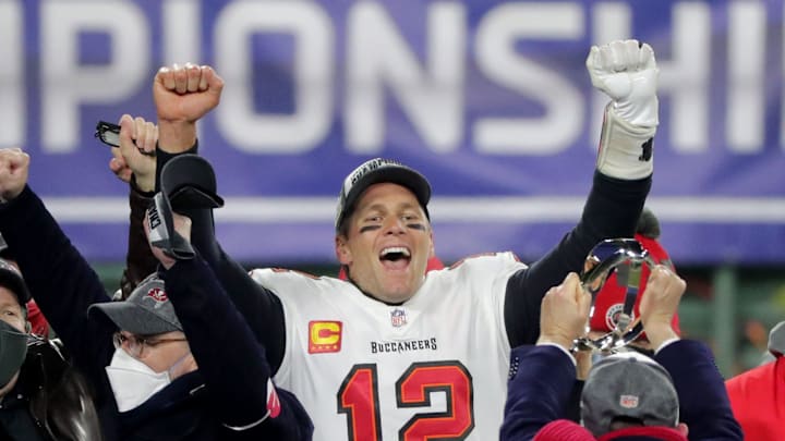 Tampa Bay Buccaneers quarterback Tom Brady celebrates during the presentation of the George Halas Trophy after the 31-26 win over the Green Bay Packers. Tampa Bay Buccaneers quarterback Tom Brady celebrates during the presentation of the George Halas Trophy after the 31-26 win over the Green Bay Packers.