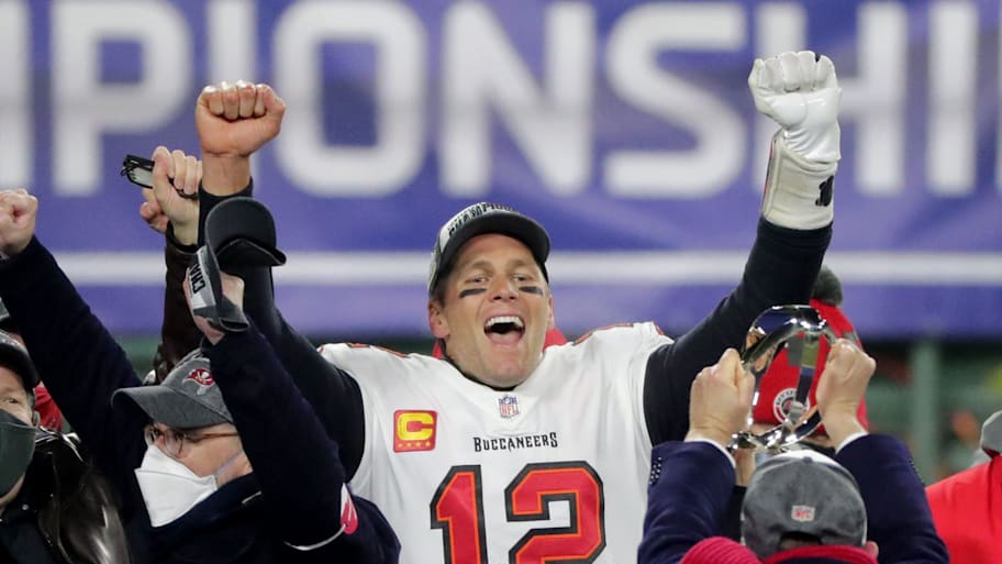 Tampa Bay Buccaneers quarterback Tom Brady celebrates during the presentation of the George Halas Trophy after the 31-26 win over the Green Bay Packers. | Mark Hoffman via Imagn Content Services, LLC
