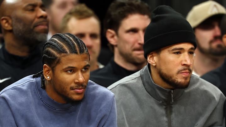 Phoenix Suns injured guard Jalen Green (left) and Devin Booker on the bench against the Detroit Pistons in the first half at Mortgage Matchup Center on Jan 9, 2026. 