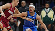 Nov 24, 2025; Miami, Florida, USA; Dallas Mavericks guard Ryan Nembhard (9) drives past Miami Heat forward Simone Fontecchio (0) during the second half at Kaseya Center. Mandatory Credit: Jim Rassol-Imagn Images