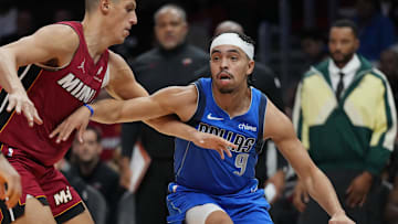 Nov 24, 2025; Miami, Florida, USA; Dallas Mavericks guard Ryan Nembhard (9) drives past Miami Heat forward Simone Fontecchio (0) during the second half at Kaseya Center. Mandatory Credit: Jim Rassol-Imagn Images