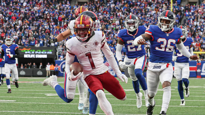 Dec 4, 2022; East Rutherford, New Jersey, USA; Washington Commanders wide receiver Jahan Dotson (1) scores on a touchdown reception during the second half in front of New York Giants safety Tony Jefferson (36) and cornerback Jason Pinnock (27) at MetLife Stadium. Mandatory Credit: Vincent Carchietta-USA TODAY Sports