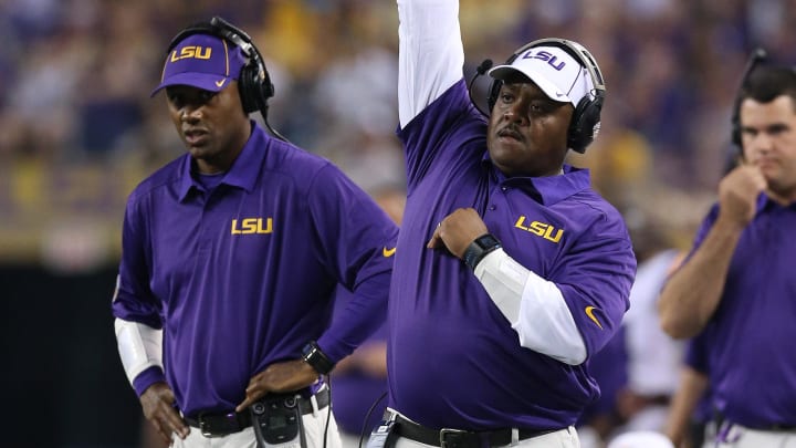 Aug 31, 2013; Arlington, TX, USA; LSU Tigers defensive backs coach Corey Raymond (left) and defensive line coach Brick Haley on the sidelines during the game against the Texas Christian Horned Frogs at AT&T Stadium. Mandatory Credit: Matthew Emmons-USA TODAY Sports