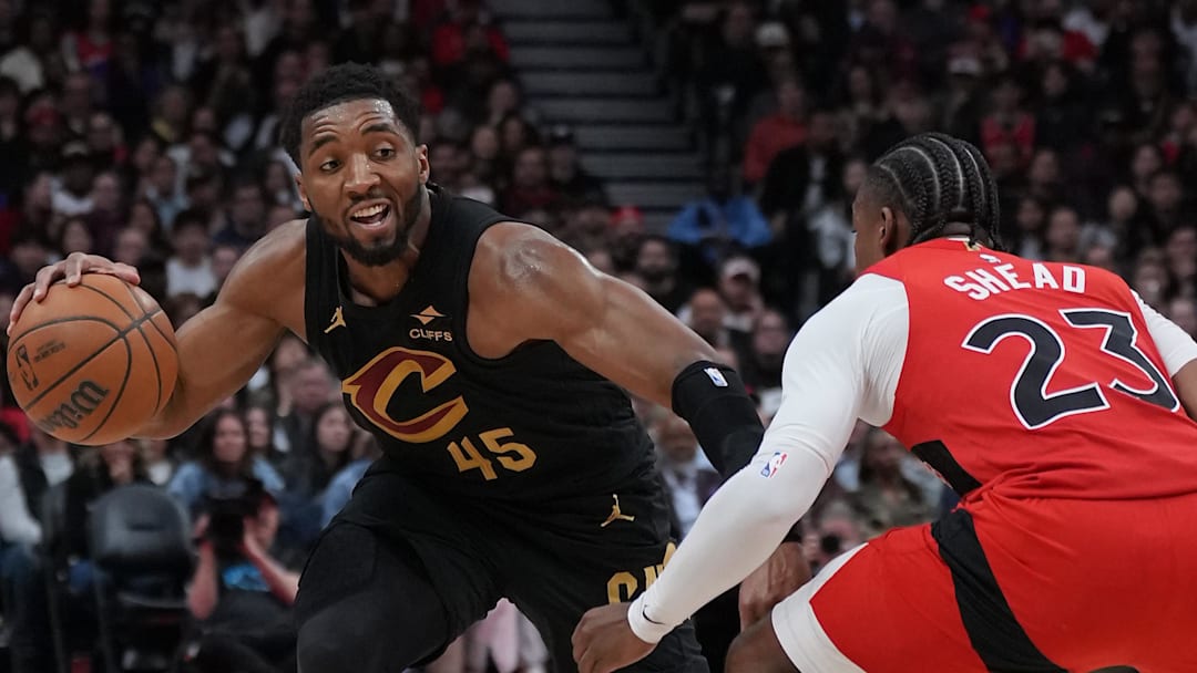 May 1, 2026; Toronto, Ontario, CAN; Cleveland Cavaliers guard Donovan Mitchell (45) controls the ball as Toronto Raptors guard Jamal Shead (23) tries to defend during the fourth quarter in game six of the first round of the 2026 NBA Playoffs at Scotiabank Arena. Mandatory Credit: Nick Turchiaro-Imagn Images
