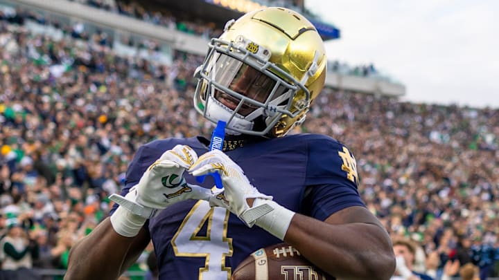 Nov 22, 2025; South Bend, Indiana, USA; Notre Dame Fighting Irish running back Jeremiyah Love (4) celebrates scoring against the Syracuse Orange during the first half at Notre Dame Stadium. Mandatory Credit: Michael Caterina-Imagn Images
