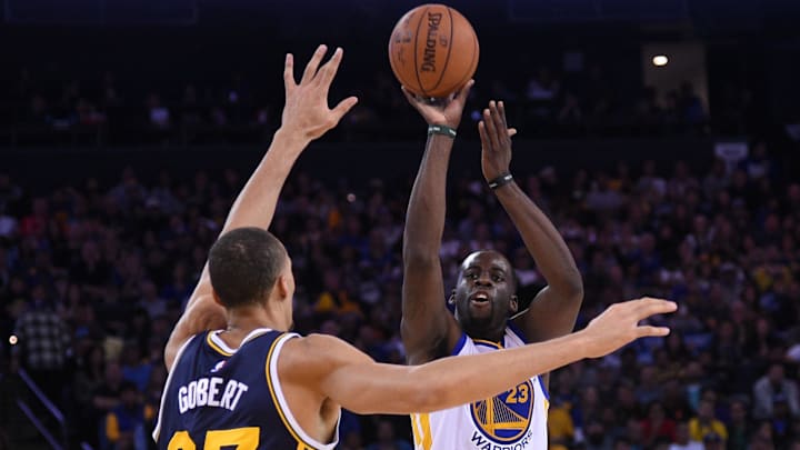 Golden State Warriors forward Draymond Green (23) shoots the basketball against former Utah Jazz center Rudy Gobert (27) during the second quarter at Oracle Arena. Golden State Warriors forward Draymond Green (23) shoots the basketball against former Utah Jazz center Rudy Gobert (27) during the second quarter at Oracle Arena.