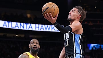 LeBron James #23 of the Los Angeles Lakers and Trae Young #11 of the Atlanta Hawks