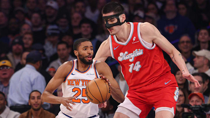 Jan 27, 2025; New York, New York, USA; New York Knicks forward Mikal Bridges (25) is guarded by Memphis Grizzlies center Zach Edey (14) and guard Ja Morant (12) during the first half at Madison Square Garden. Mandatory Credit: Vincent Carchietta-Imagn Images Jan 27, 2025; New York, New York, USA; New York Knicks forward Mikal Bridges (25) is guarded by Memphis Grizzlies center Zach Edey (14) and guard Ja Morant (12) during the first half at Madison Square Garden. Mandatory Credit: Vincent Carchietta-Imagn Images