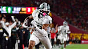 Sep 20, 2025; Los Angeles, California, USA; Michigan State Spartans wide receiver Chrishon McCray (13) scores a touchdown against the against the Southern California Trojans during the first half at the Los Angeles Memorial Coliseum. Mandatory Credit: Gary A. Vasquez-Imagn Images