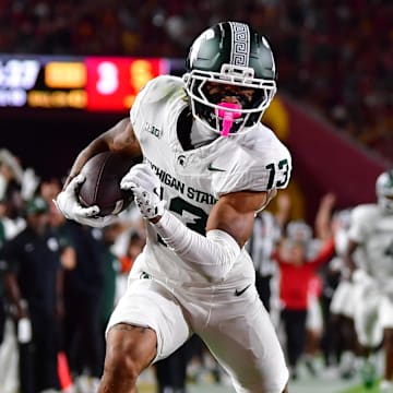 Sep 20, 2025; Los Angeles, California, USA; Michigan State Spartans wide receiver Chrishon McCray (13) scores a touchdown against the against the Southern California Trojans during the first half at the Los Angeles Memorial Coliseum. Mandatory Credit: Gary A. Vasquez-Imagn Images