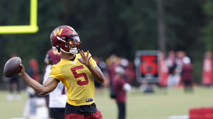 Jul 26, 2024; Ashburn, VA, USA; Washington Commanders quarterback Jayden Daniels (5) passes the ball on day three of training camp at Commanders Park. Mandatory Credit: Geoff Burke-USA TODAY Sports