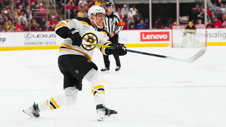 Oct 31, 2024; Raleigh, North Carolina, USA; Boston Bruins defenseman Hampus Lindholm (27) takes a shot against the Carolina Hurricanes during the second period at Lenovo Center. Mandatory Credit: James Guillory-Imagn Images Oct 31, 2024; Raleigh, North Carolina, USA; Boston Bruins defenseman Hampus Lindholm (27) takes a shot against the Carolina Hurricanes during the second period at Lenovo Center. Mandatory Credit: James Guillory-Imagn Images