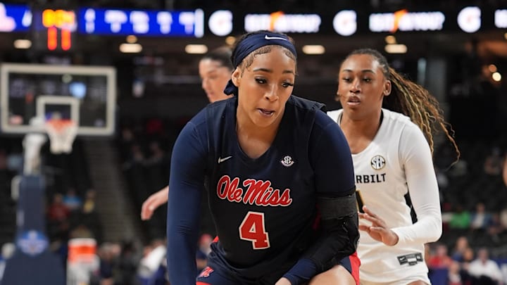Mar 6, 2026; Greenville, SC, USA; Mississippi Rebels forward Jayla Murray (4) handles the ball guarded by Vanderbilt Commodores guard Mikayla Blakes (1) during the first half at Bon Secours Wellness Arena. Mandatory Credit: Jim Dedmon-Imagn Images