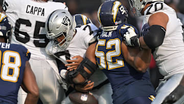 Nov 30, 2025; Inglewood, California, USA; Las Vegas Raiders quarterback Geno Smith (7) fumbles the ball against the Los Angeles Chargers during the first half at SoFi Stadium. Mandatory Credit: Jayne Kamin-Oncea-Imagn Images