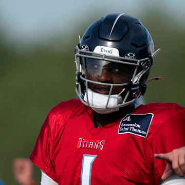 Tennessee Titans quarterback Cam Ward works with quarterbacks coach Bo Hardegree during training camp.