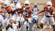 Sep 6, 2025; Austin, Texas, USA; Texas Longhorns kick returner Ryan Niblett (21) is tackled by San Jose State Spartans linebacker Ethan Powell (26) during the opening kickoff at Darrell K Royal-Texas Memorial Stadium. Mandatory Credit: Scott Wachter-Imagn Images