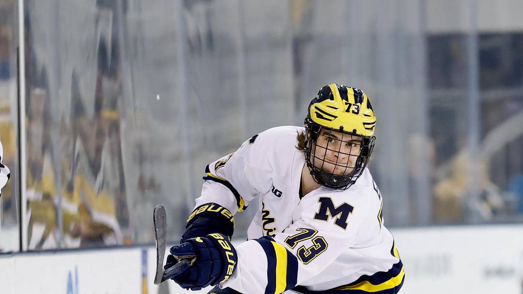 Mar 7, 2025; Ann Arbor, MI, USA;  Michigan Wolverines forward T.J. Hughes (13) passes against Penn State  during a Big Ten Tournament quarter final game at Yost Arena. Mandatory Credit: Rick Osentoski-Imagn Images